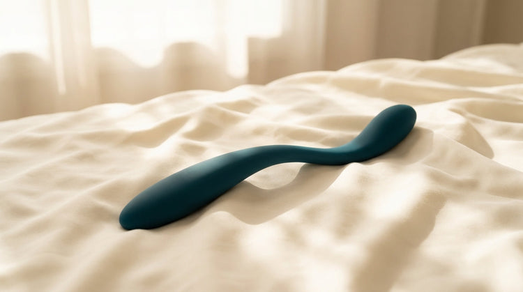 Abstract double ended silicone pleasure tool on soft silk bedding