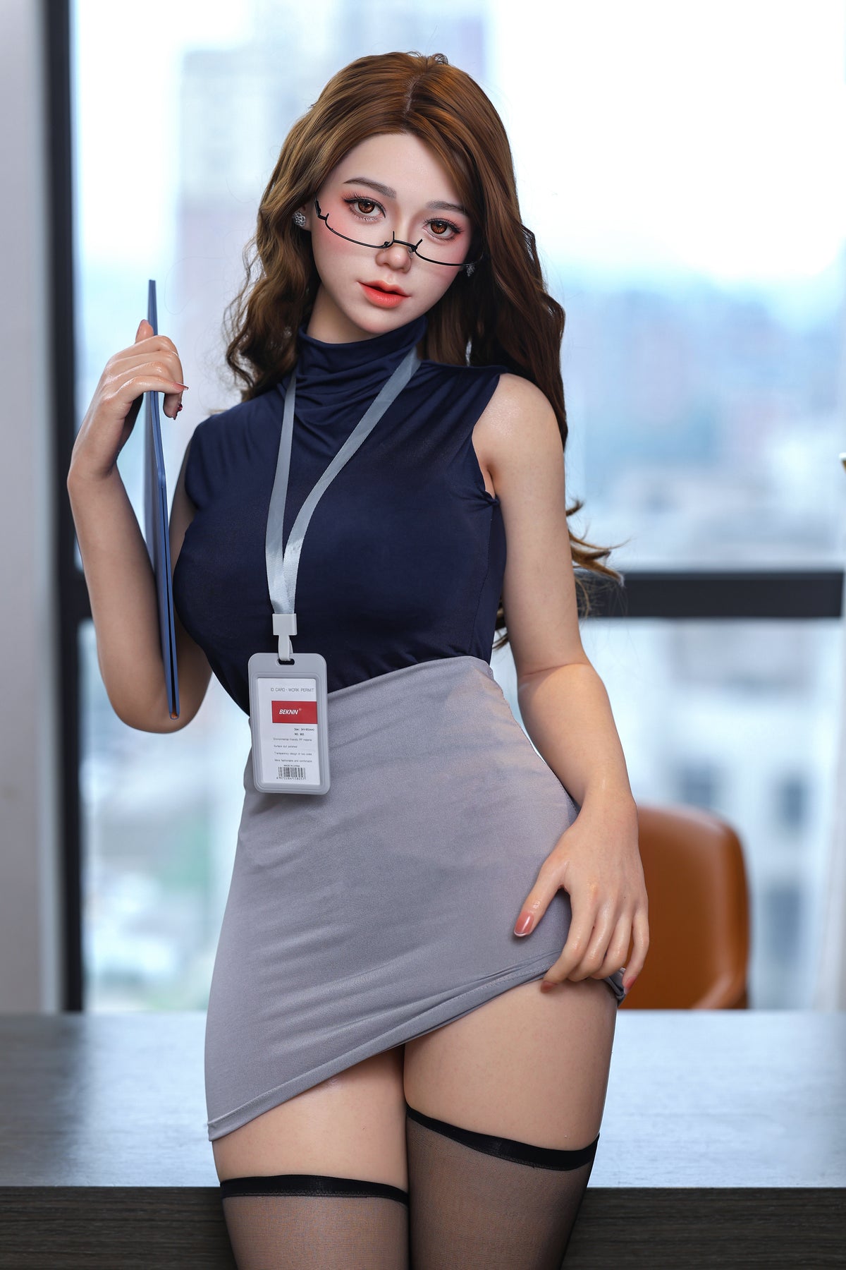 Angie holding a folder in her office
