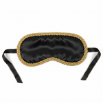 Luxurious black satin blindfold with gold trim on white background